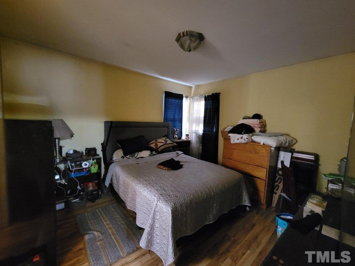 3336 Fairground Road Dunn, NC 28334 - Photo 4 of 11 a bedroom with bed a table and chair