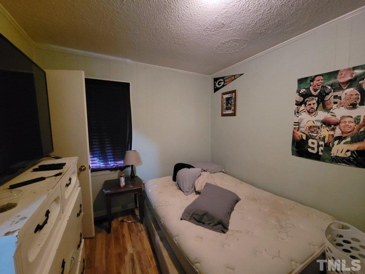 3336 Fairground Road Dunn, NC 28334 - Photo 6 of 11 a bedroom with a bed and a flat screen tv