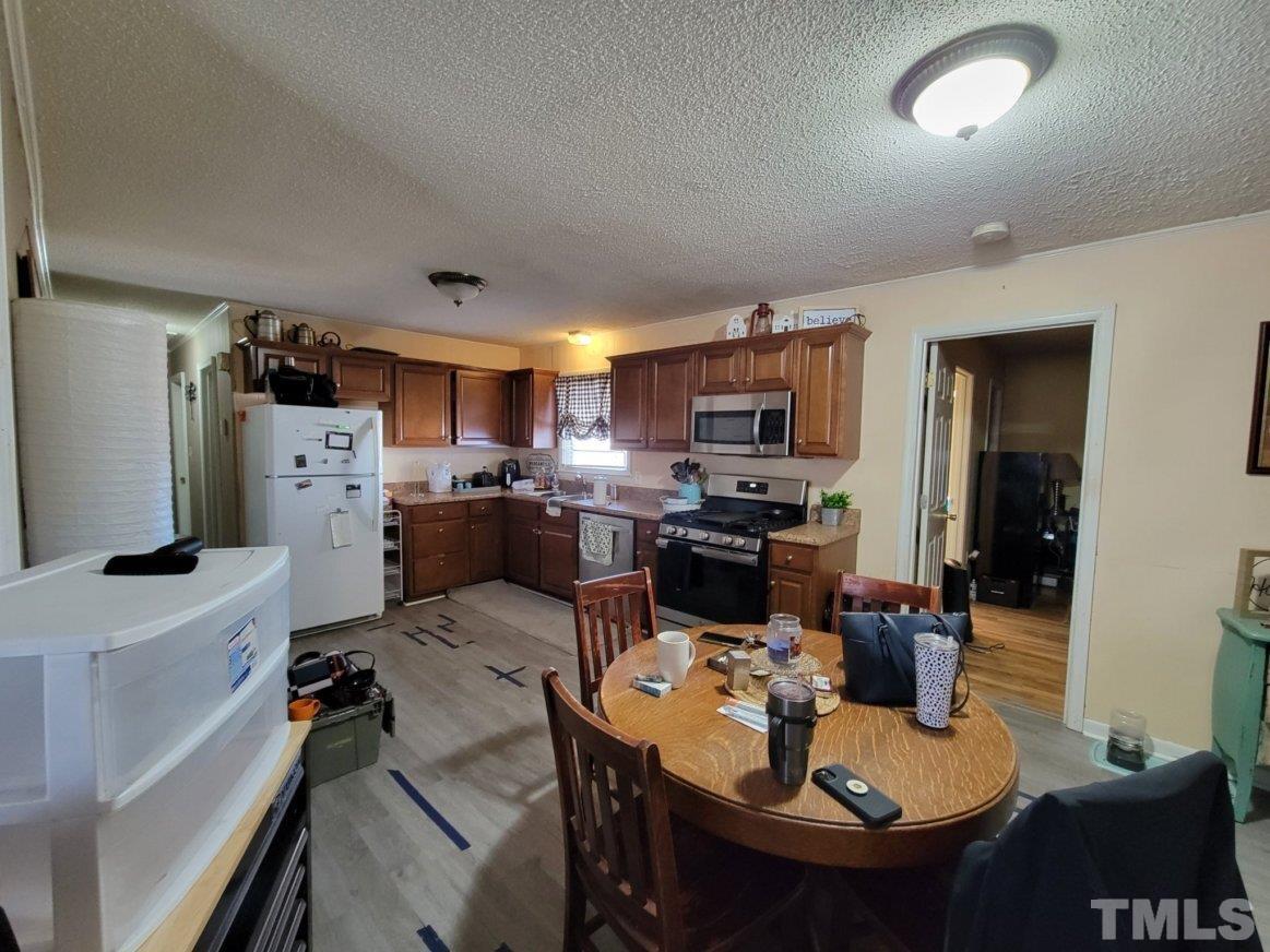 3336 Fairground Road Dunn, NC 28334 - Photo 9 of 11 a kitchen with a sink appliances and chairs
