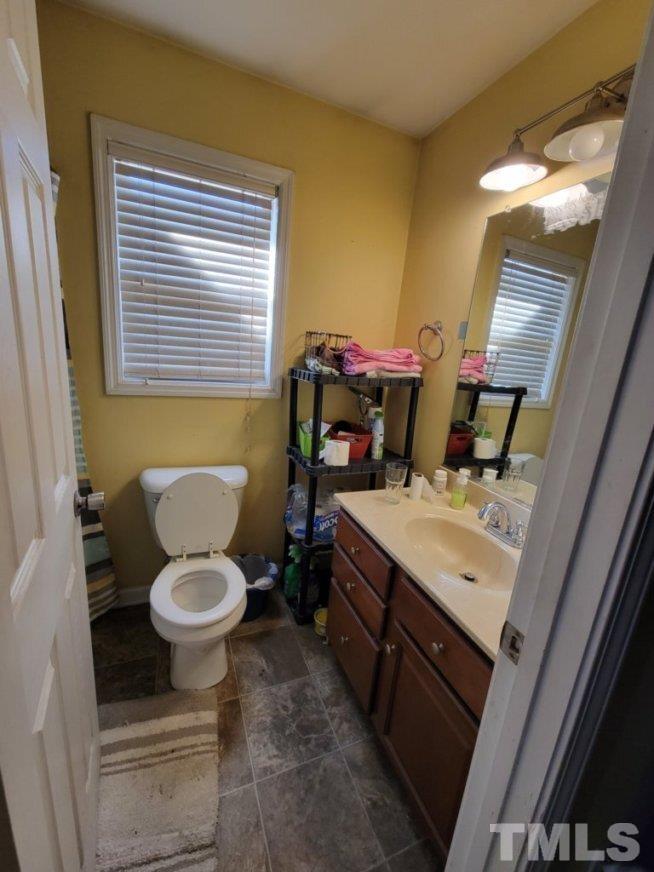 3336 Fairground Road Dunn, NC 28334 - Photo 10 of 11 a bathroom with a toilet sink and mirror