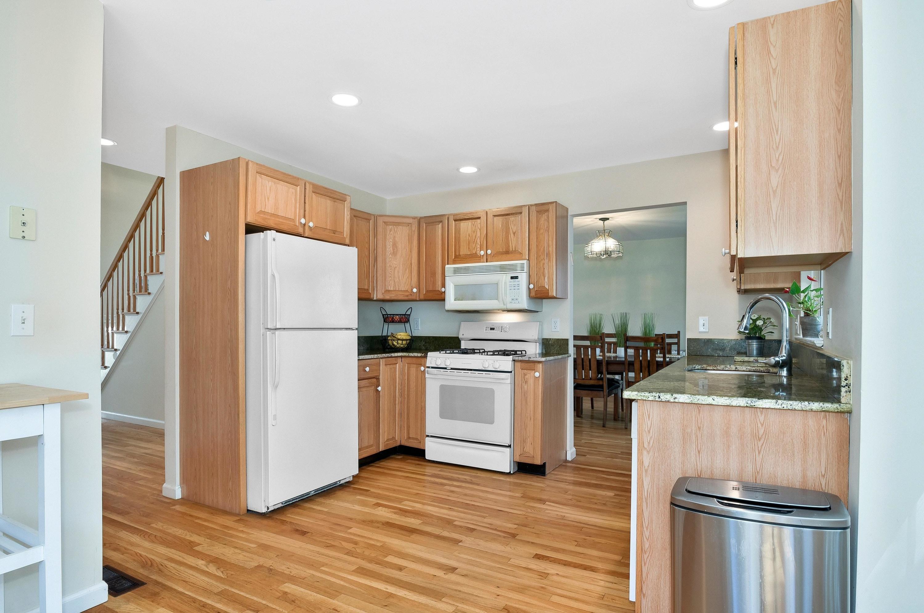 168 Colonial Road, Unit 10 Stamford, CT 06906 - Photo 11 of 27 a kitchen with a refrigerator a stove top oven and cabinets