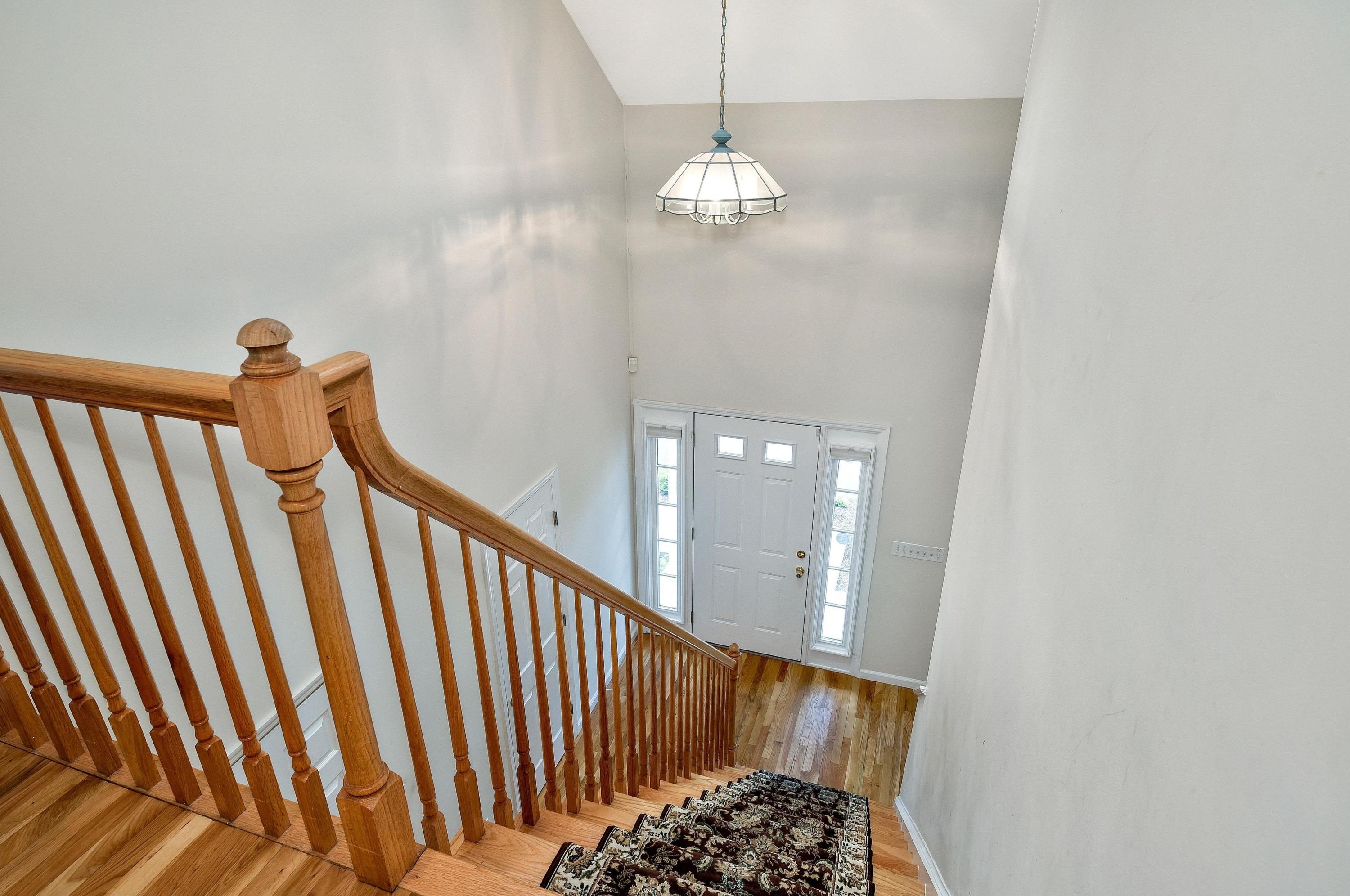 168 Colonial Road, Unit 10 Stamford, CT 06906 - Photo 14 of 27 a view of staircase with railing and a chandelier
