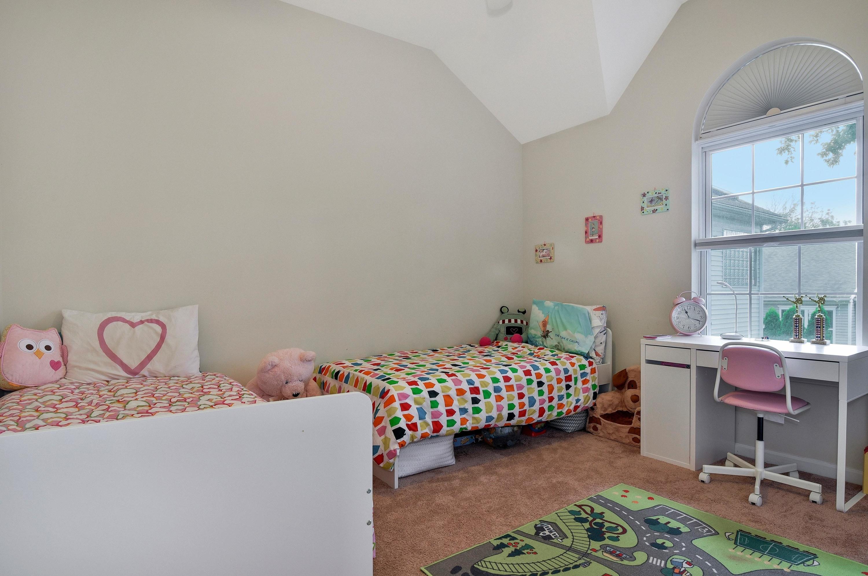 168 Colonial Road, Unit 10 Stamford, CT 06906 - Photo 20 of 27 a bedroom with a bed and a chair