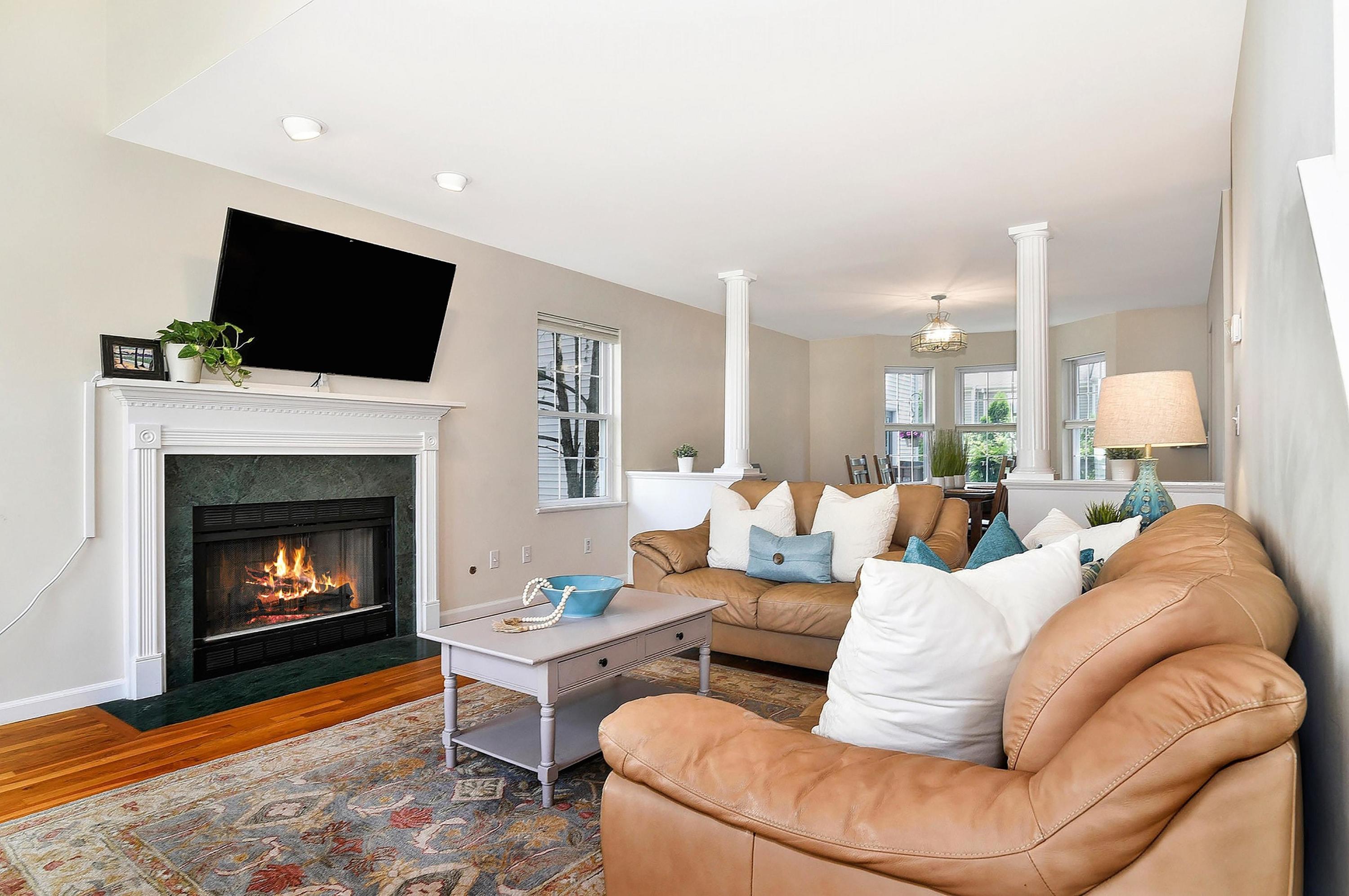 168 Colonial Road, Unit 10 Stamford, CT 06906 - Photo 4 of 27 a living room with furniture a flat screen tv and a fireplace