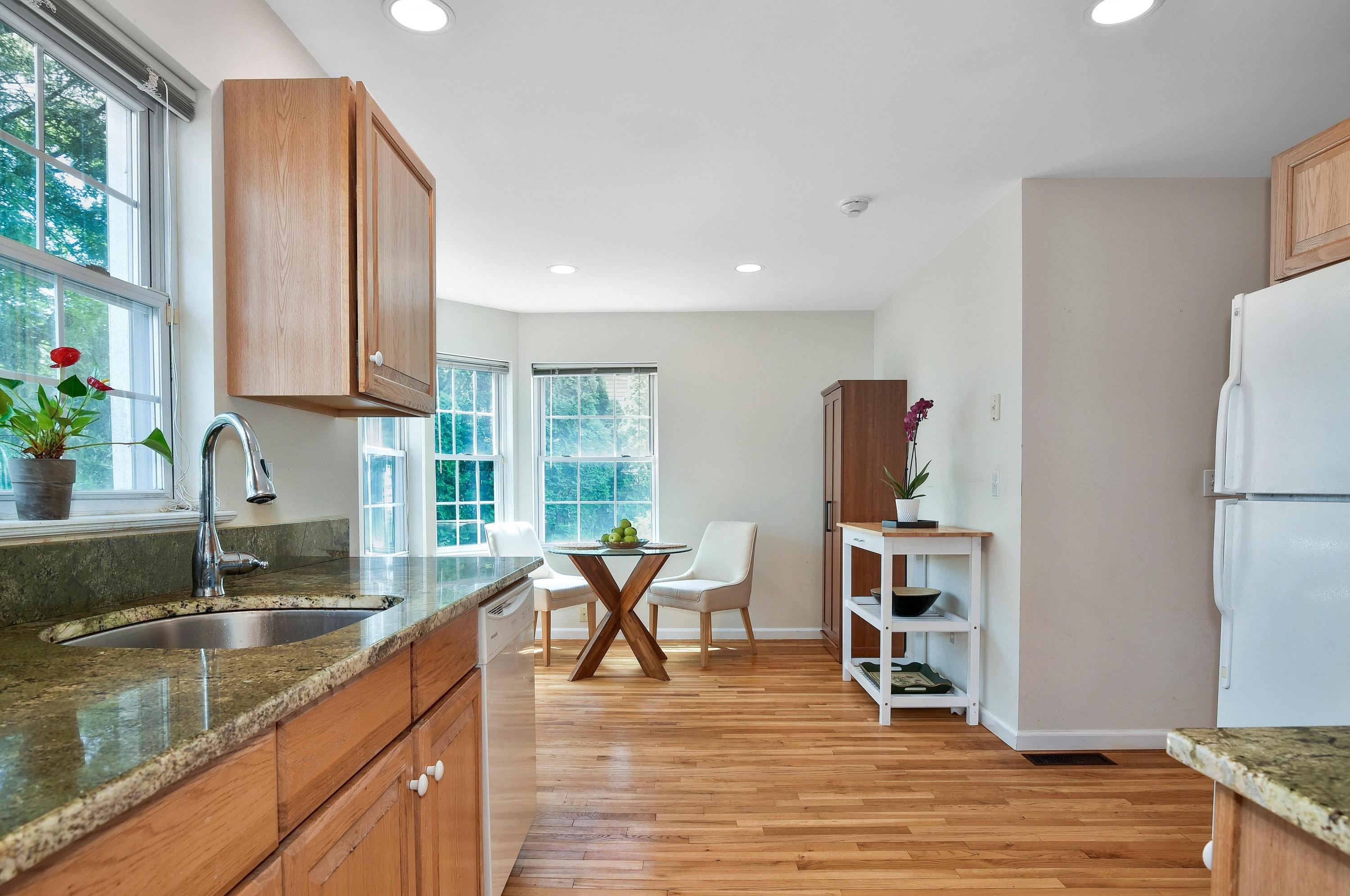 168 Colonial Road, Unit 10 Stamford, CT 06906 - Photo 9 of 27 a kitchen with stainless steel appliances granite countertop a refrigerator and a sink