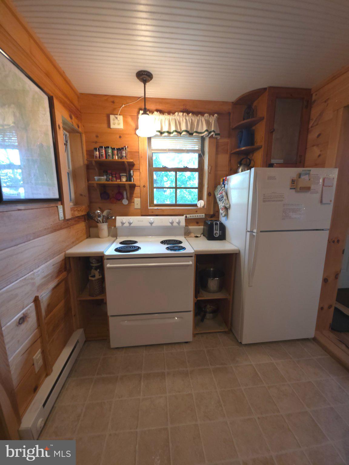 152 Sharp Ridge Lane Franklin, WV 26807 - Photo 12 of 53 a kitchen with a refrigerator and a stove