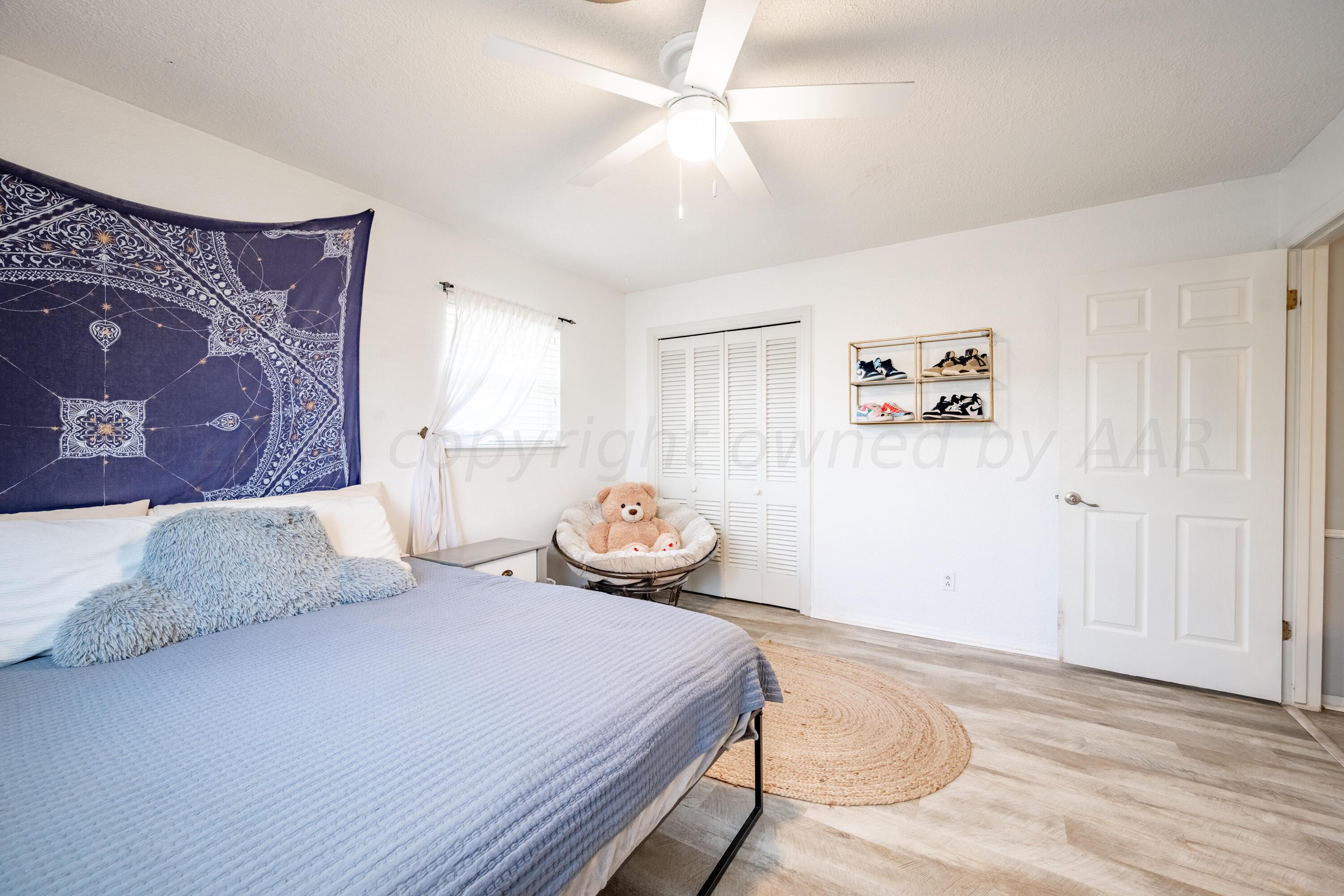 3313 Bedford Road Amarillo, TX 79106 - Photo 17 of 24 a bedroom with a bed and a painting on the wall