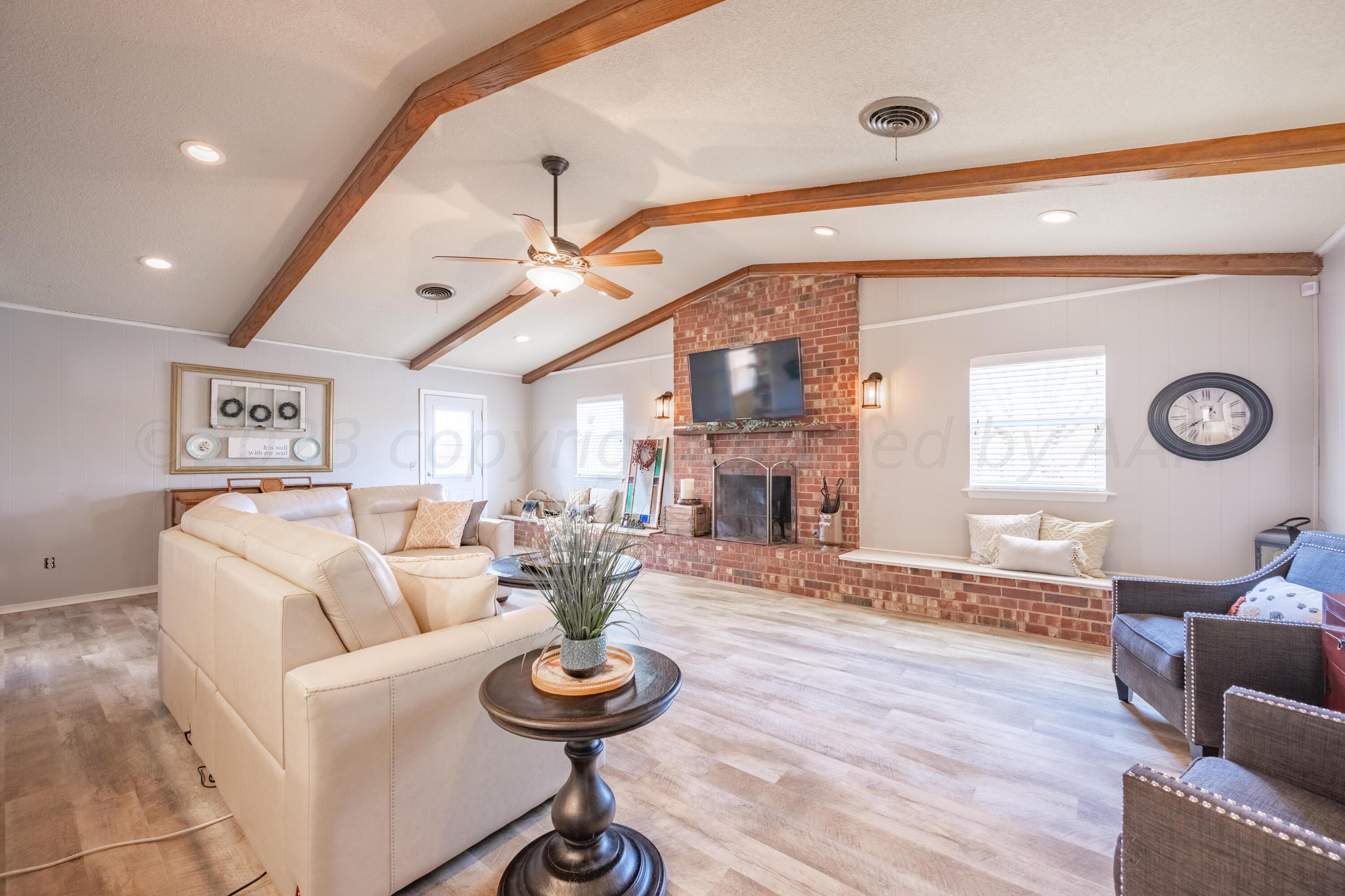 3313 Bedford Road Amarillo, TX 79106 - Photo 5 of 24 a living room with furniture and a wooden floor