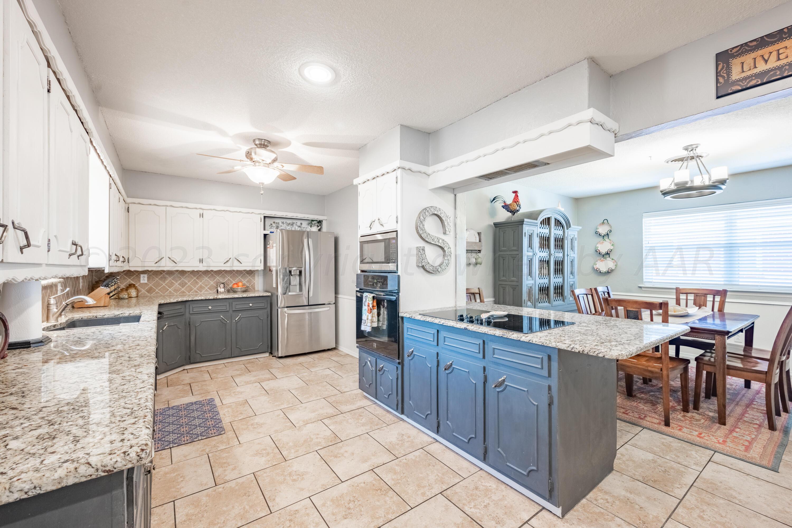 3313 Bedford Road Amarillo, TX 79106 - Photo 8 of 24 a large kitchen with cabinets in it and stainless steel appliances