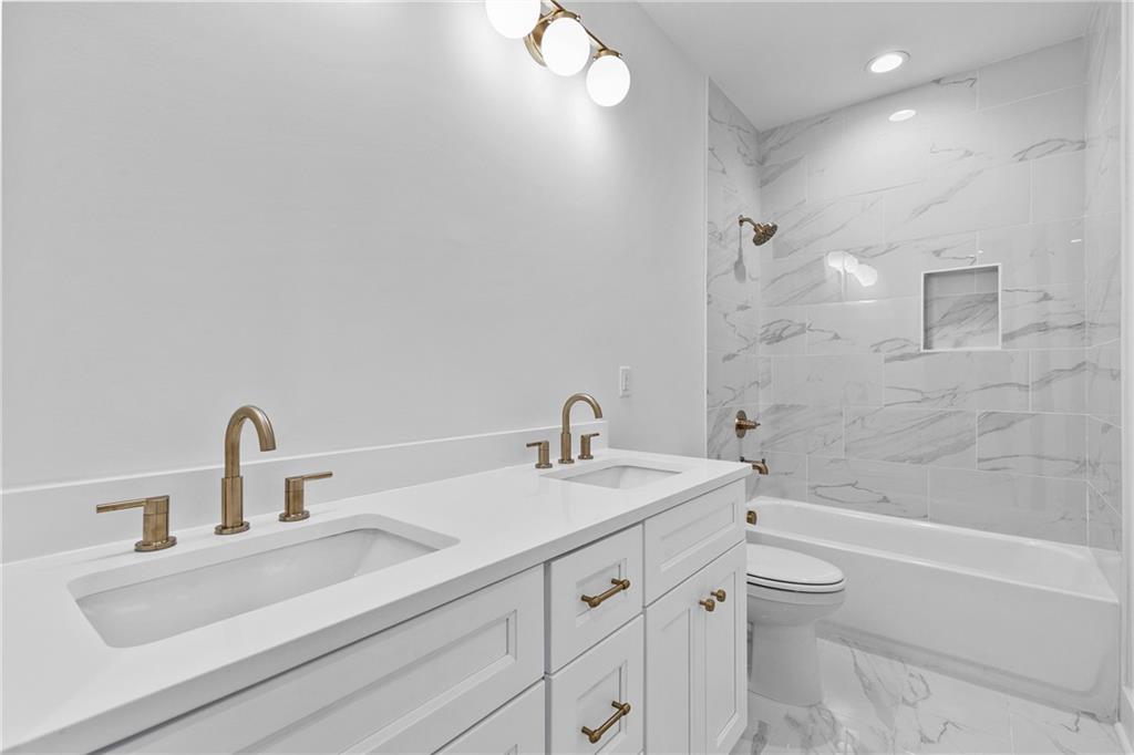 345 Sugarview Road Sugar Hill, GA 30518 - Photo 29 of 66 a bathroom with a sink vanity granite tub toilet and shower