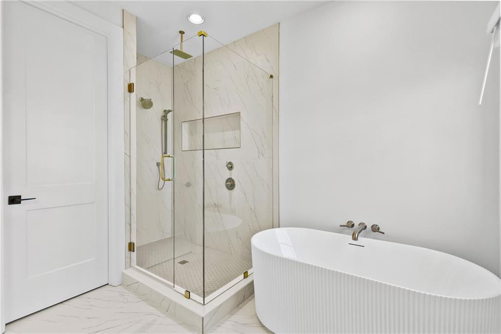 345 Sugarview Road Sugar Hill, GA 30518 - Photo 35 of 66 a bathroom with a bathtub and shower