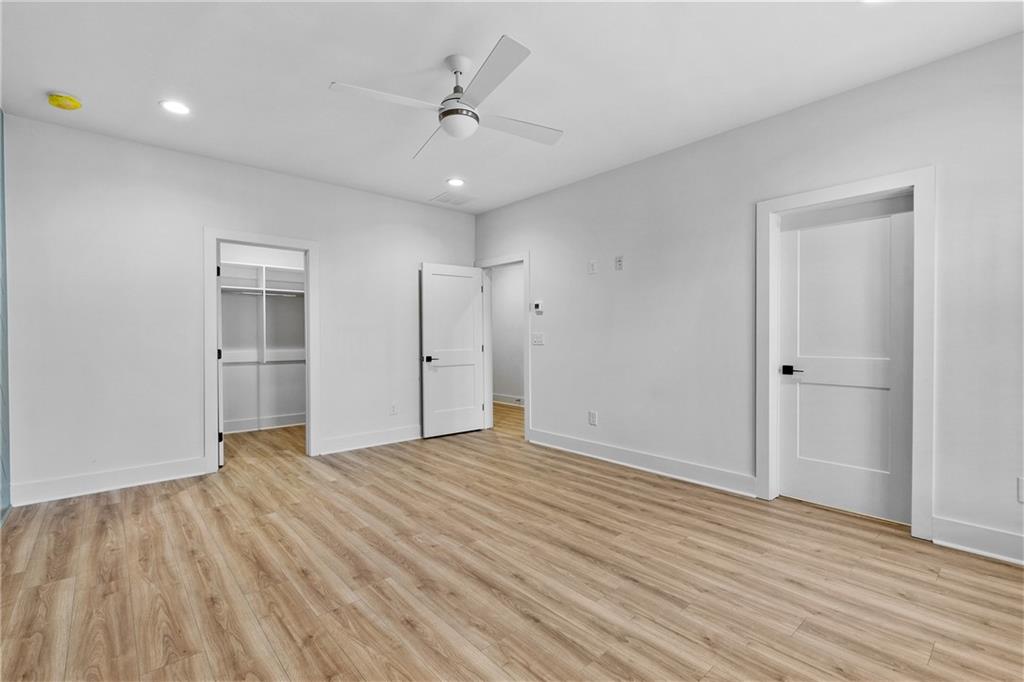 345 Sugarview Road Sugar Hill, GA 30518 - Photo 39 of 66 a view of an empty room with wooden floor and a ceiling fan