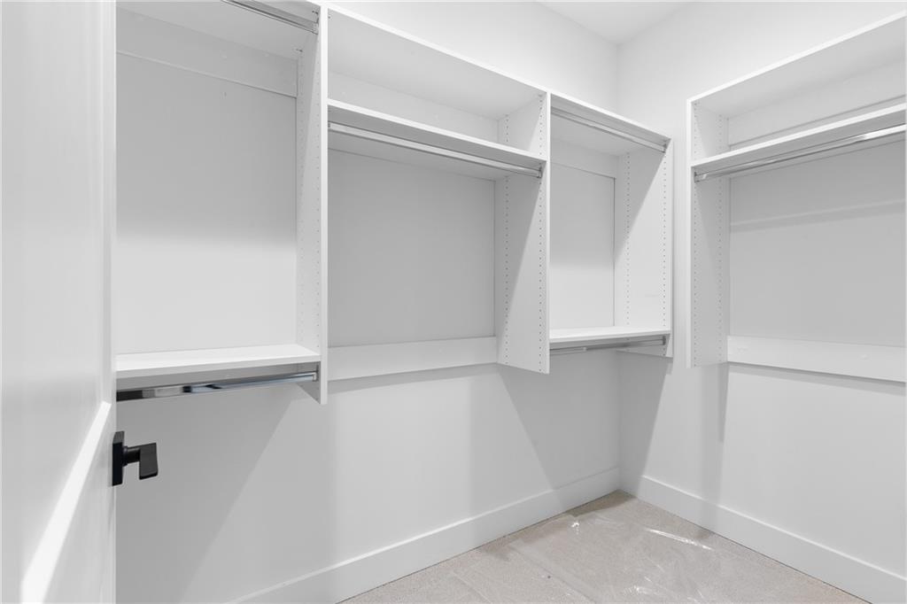 345 Sugarview Road Sugar Hill, GA 30518 - Photo 41 of 66 a view of walk in closet with empty racks