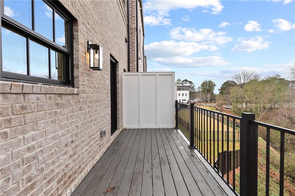 345 Sugarview Road Sugar Hill, GA 30518 - Photo 52 of 66 a view of a balcony with wooden floor and fence