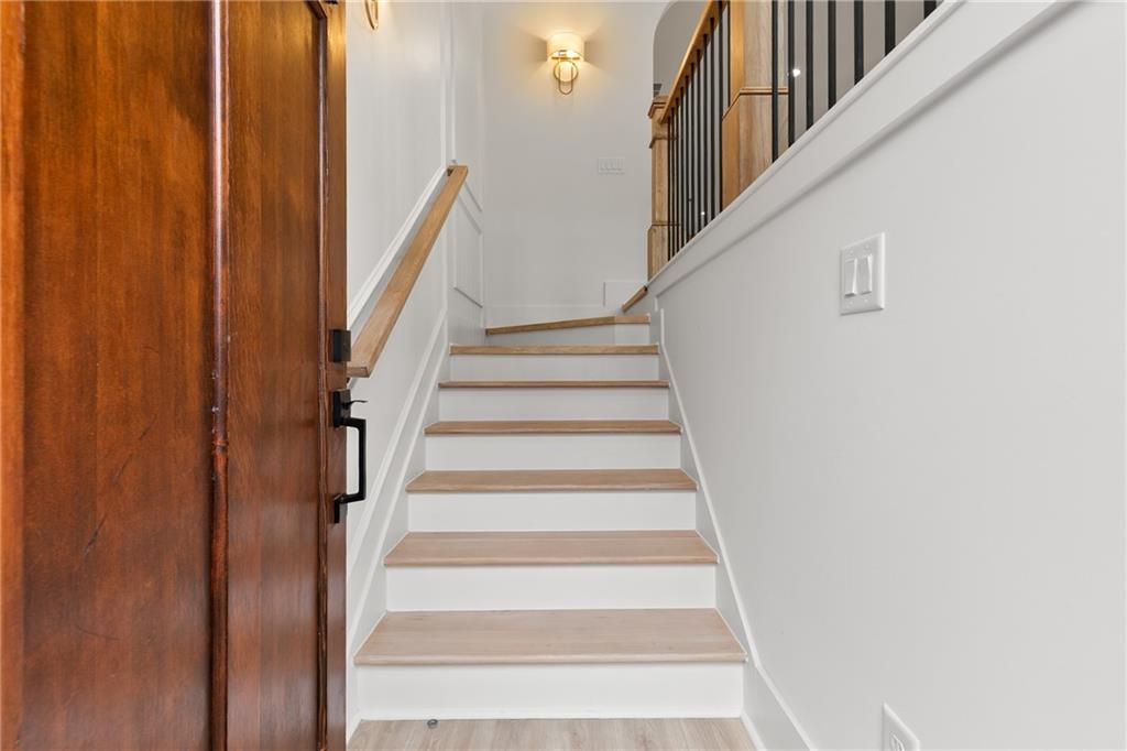 345 Sugarview Road Sugar Hill, GA 30518 - Photo 8 of 66 a view of staircase with lots of frames on wall