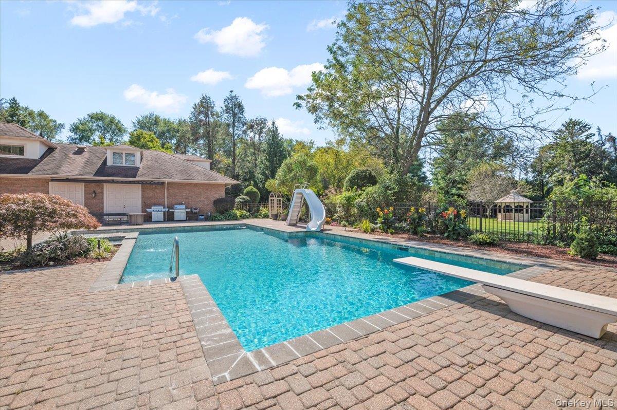 12 Ridge Court Glen Head, NY 11545 - Photo 41 of 46 View of pool featuring a water slide, a patio area, a diving board, and grilling area