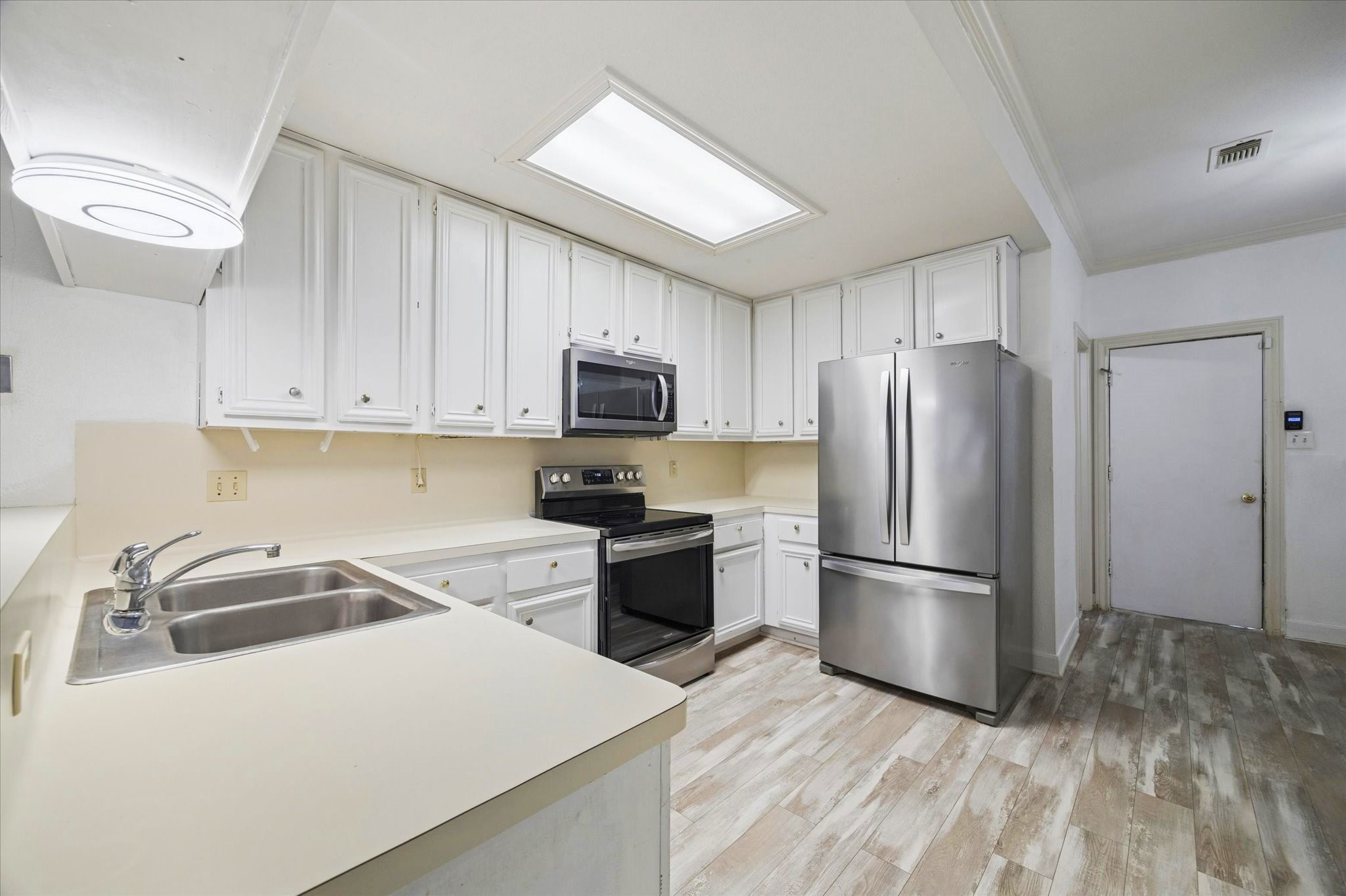 880 Tully Street, Unit 13 Houston, TX 77079 - Photo 1 of 27 a kitchen with a refrigerator sink and microwave