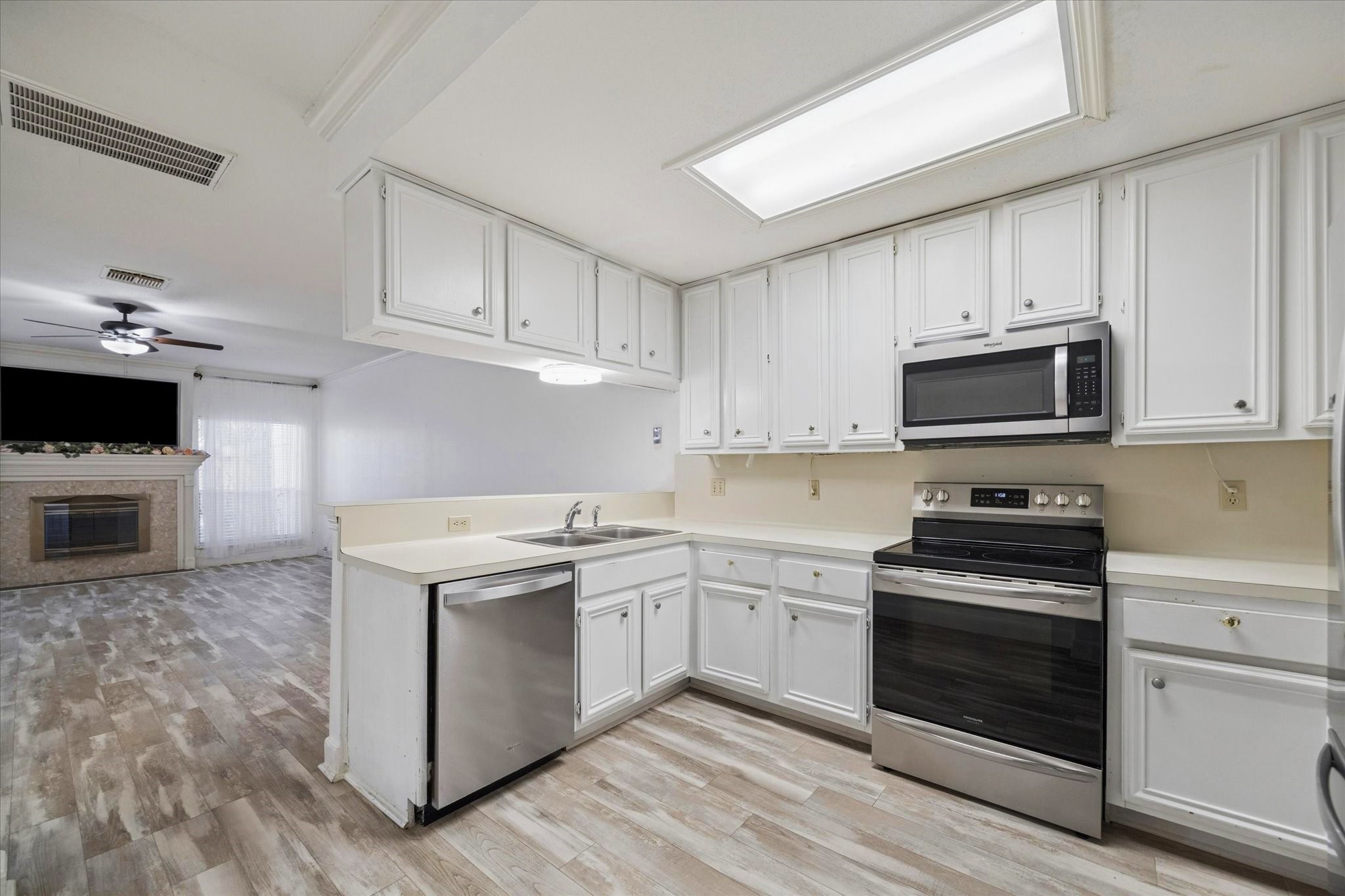880 Tully Street, Unit 13 Houston, TX 77079 - Photo 11 of 27 a kitchen with cabinets stainless steel appliances and sink