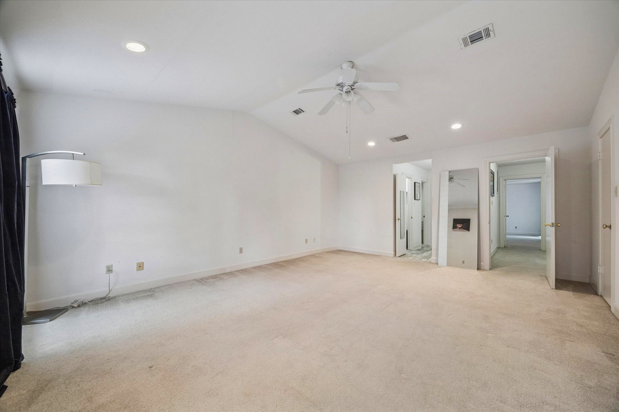 880 Tully Street, Unit 13 Houston, TX 77079 - Photo 17 of 27 an empty room with a ceiling fan and hallway