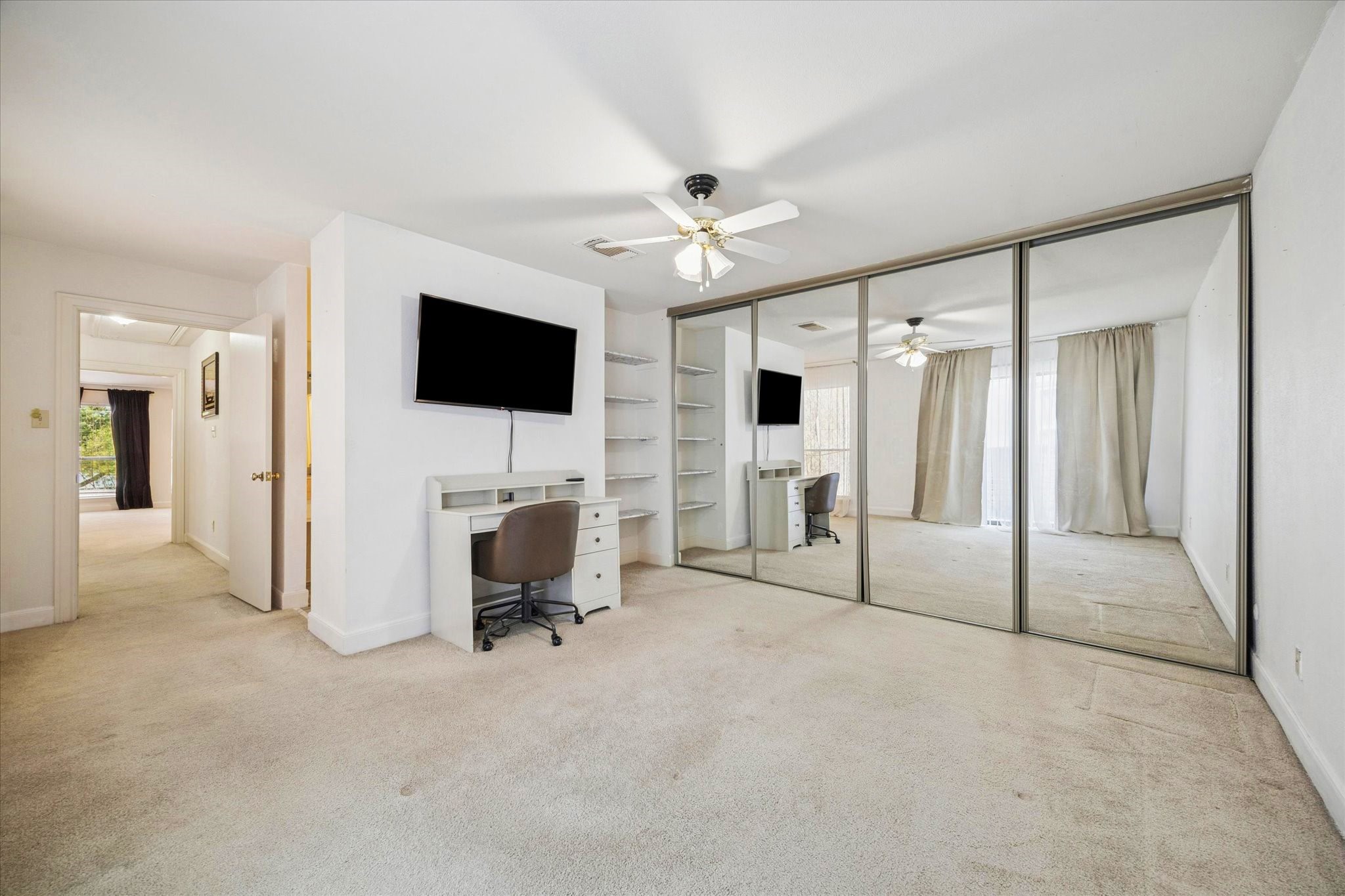 880 Tully Street, Unit 13 Houston, TX 77079 - Photo 19 of 27 a view of a livingroom with entryway and a ceiling fan