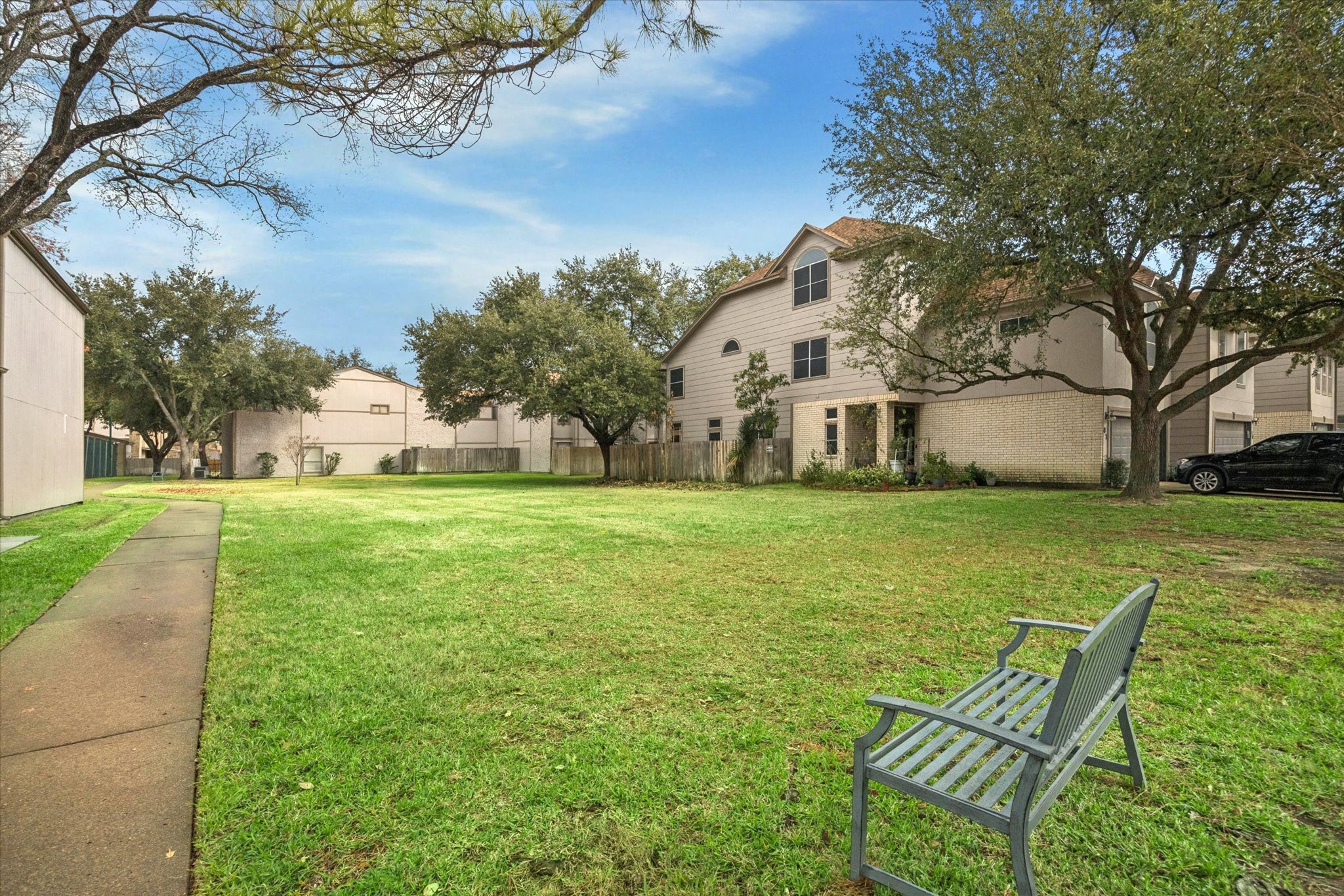 880 Tully Street, Unit 13 Houston, TX 77079 - Photo 25 of 27 a view of a house with a yard