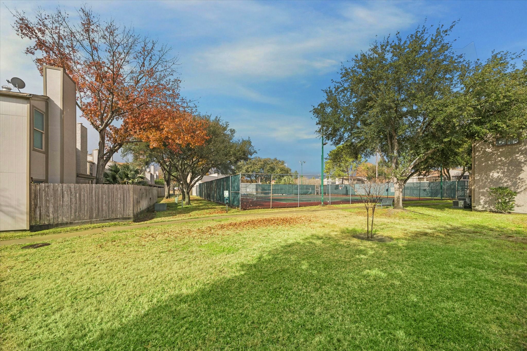 880 Tully Street, Unit 13 Houston, TX 77079 - Photo 6 of 27 a swimming pool with wooden fence