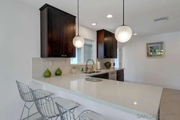 a kitchen with stainless steel appliances granite countertop wooden cabinets a sink and dishwasher