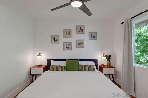 a bedroom with a bed and a window