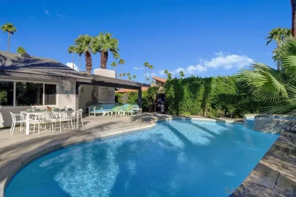 a view of backyard with seating space and trees