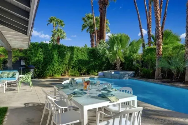 a view of an outdoor sitting area with furniture and garden view