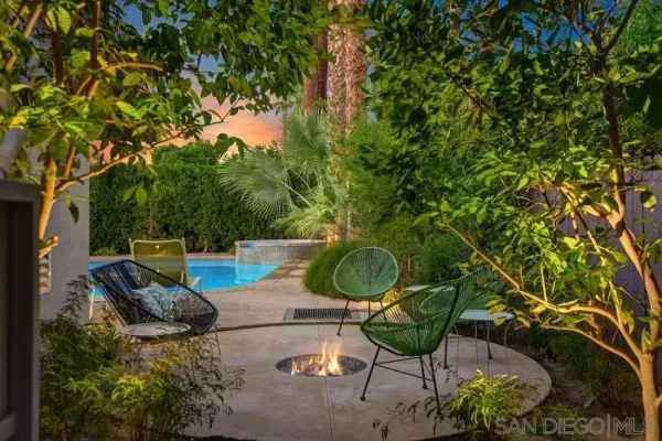 a backyard of a house with table and chairs