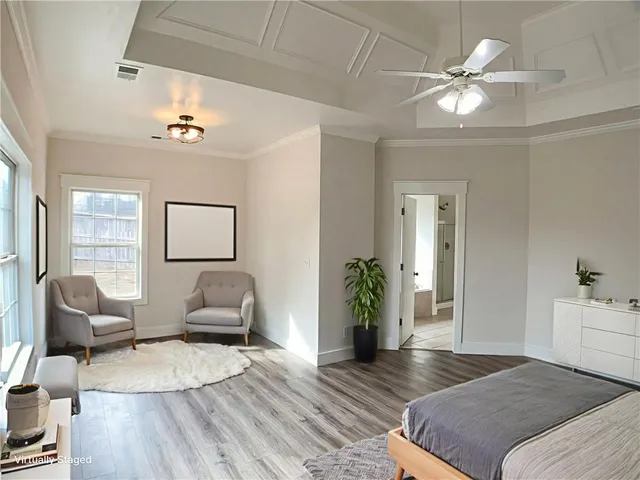 a spacious bedroom with a bed and furniture