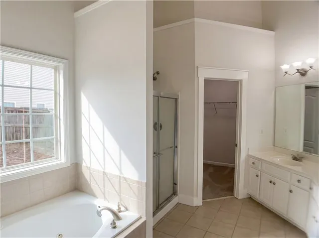 a bathroom with a tub sink and mirror
