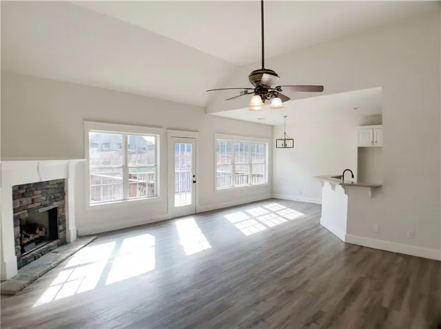 a view of an empty room with a fireplace and a window