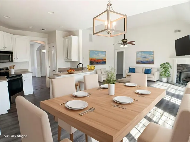 a view of a dining room with furniture and a kitchen