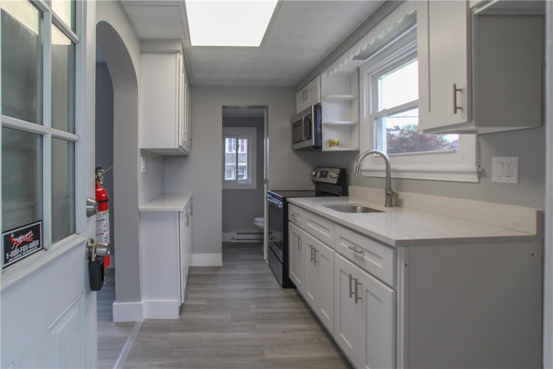 933 Philadelphia Road Easton, PA 18042 - Photo 10 of 23 Crisp cabinetry and streamlined countertops define this efficiently designed kitchen workspace.