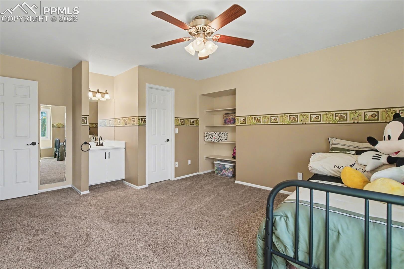 1375 Blueberry Hills Road Monument, CO 80132 - Photo 33 of 49 Large bedroom with walk-in closet and vanity.