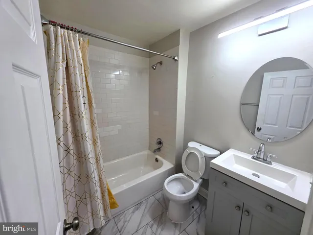 a view of room with window and hardwood floor