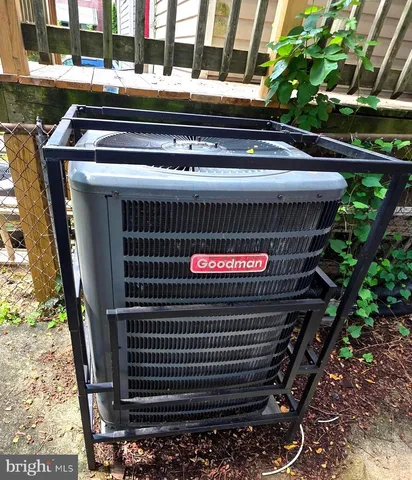 a view of staircase with lots of frames on wall and wooden floor