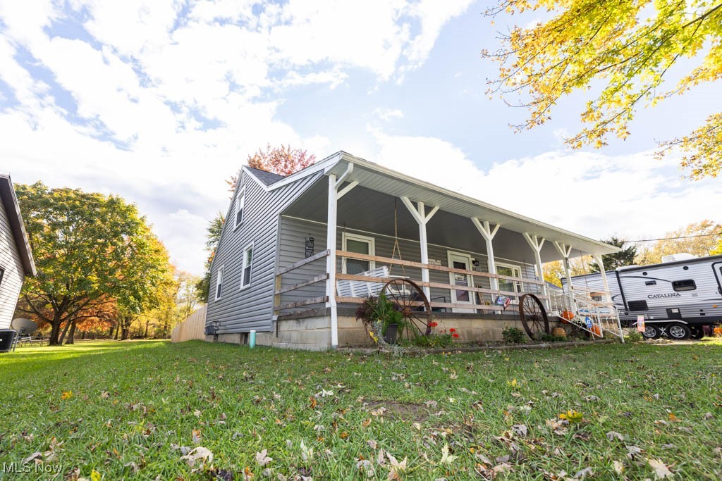 View of front of home with a front lawn and a porch