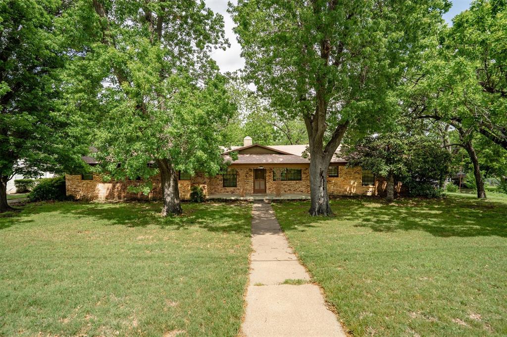 5000 Circle Ridge Drive West Fort Worth, TX 76114 - Photo 1 of 1 The property features a brick exterior, a walkway leading to the front entrance, and a lawn with mature trees