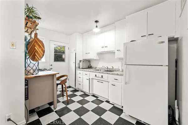 a kitchen with stainless steel appliances a refrigerator sink and cabinets