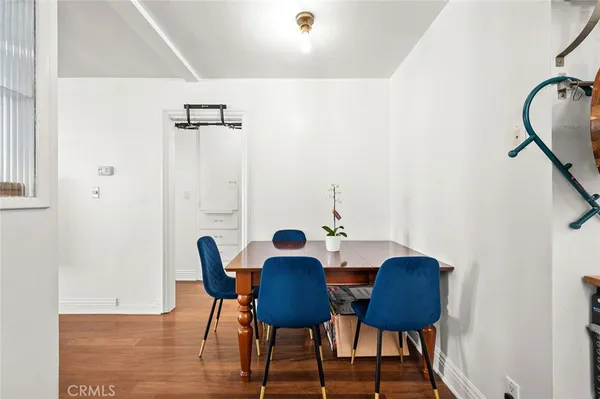 a view of a dining room with furniture and wooden floor