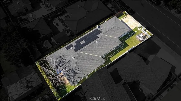 an aerial view of a house with a yard