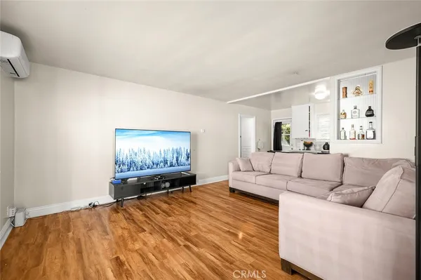 a living room with furniture and a bed