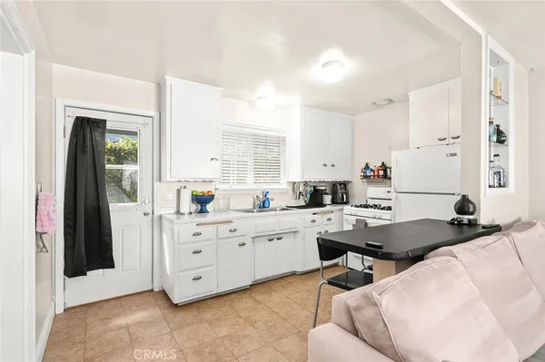 a large white kitchen with cabinets