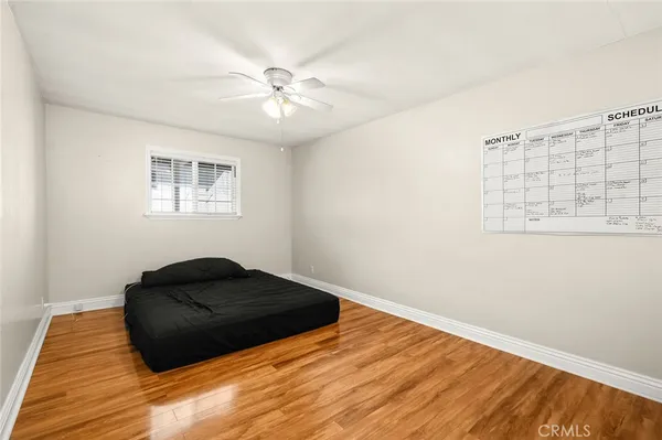 a bedroom with a bed window and a ceiling fan