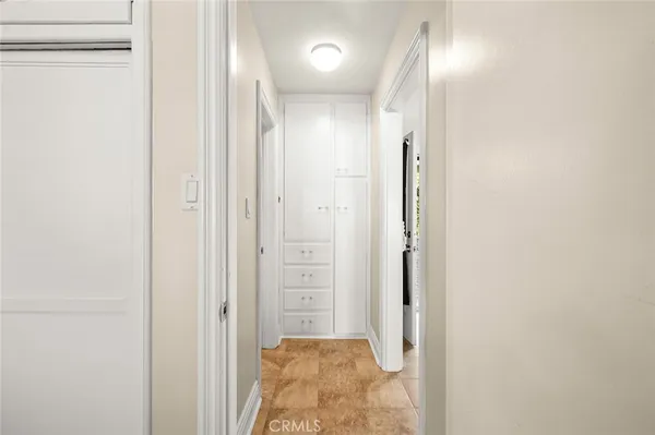 a view of a hallway with wooden floor and closet