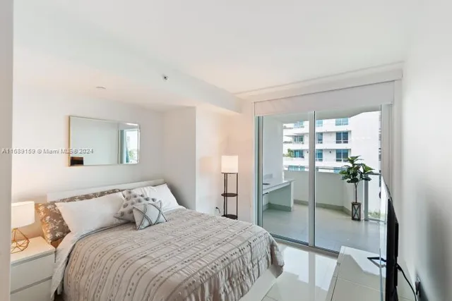 a bedroom with a bed and a mirror