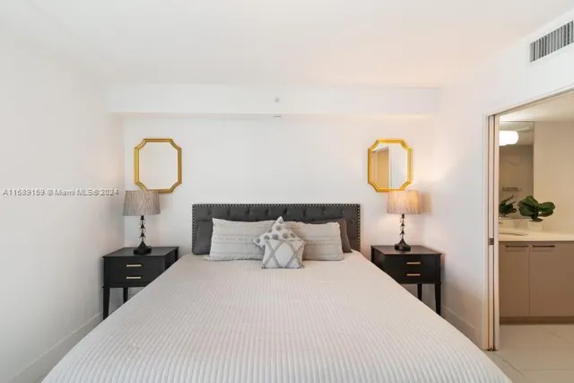 a bedroom with a bed and a mirror